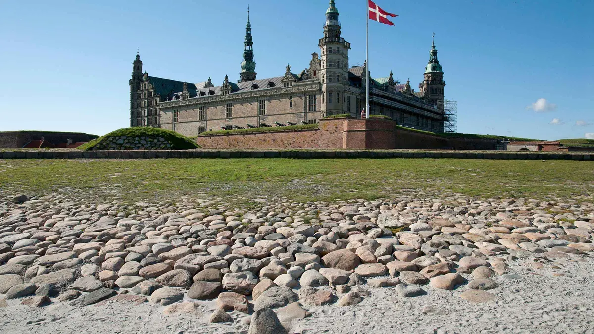 Kronborg Castle with the Danish flag over the ramparts on a Hamlet Castle tour with Roskilde and the Viking ships